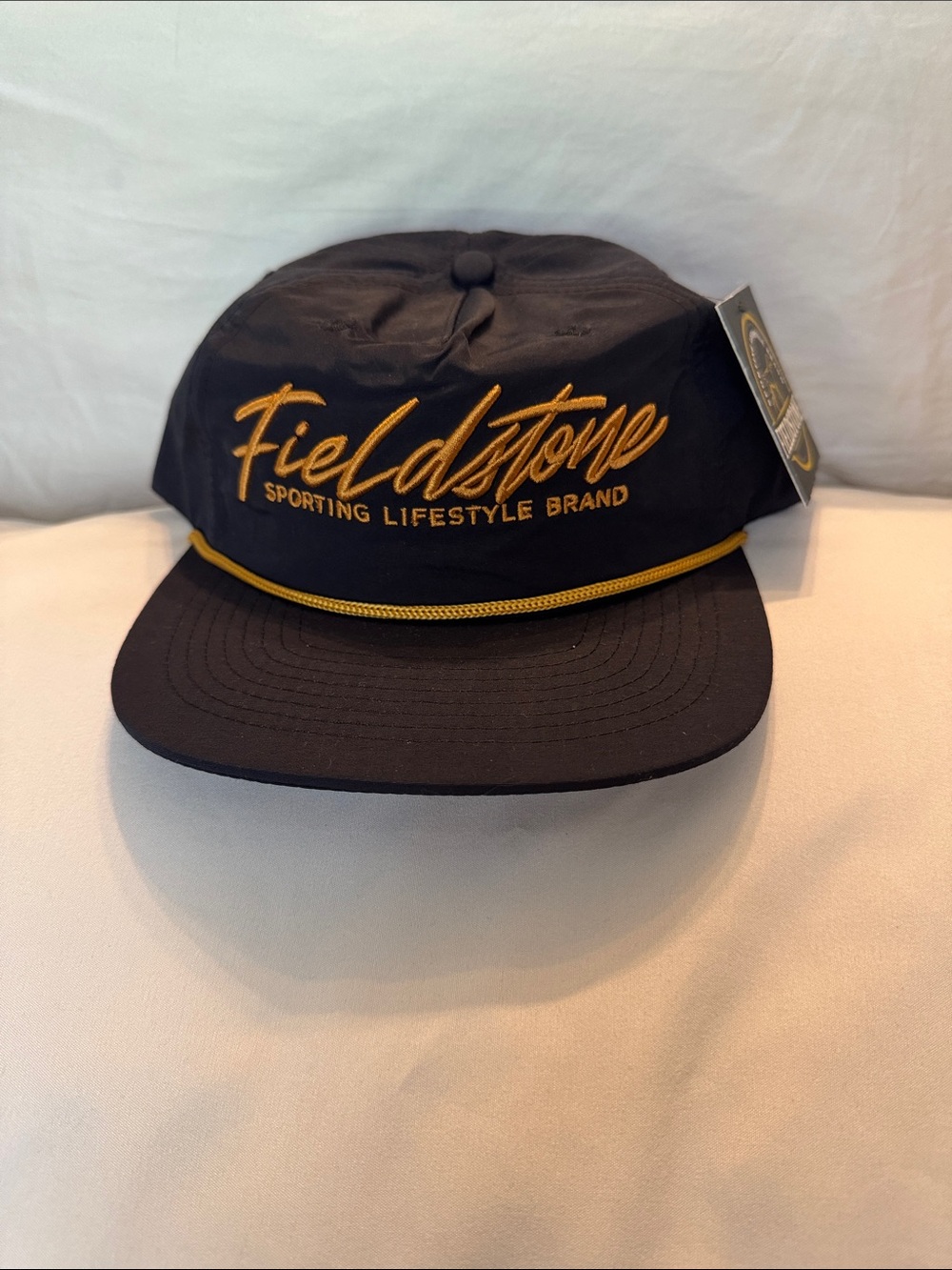 Fieldstone Black Cap with Gold Script and Rope Trim